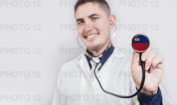 Doctor showing stethoscope with Liechtenstein flag. Liechtenstein national healthcare concept