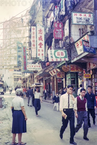 Captioned as 'Chinese flower stalls', Victoria, Hong Kong, Asia 1964 - note bamboo scaffolding