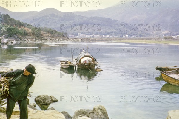 People living on sampan boats at Tai Po Hoi, New Territories, Hong Kong, Asia, 1964 woman carrying
