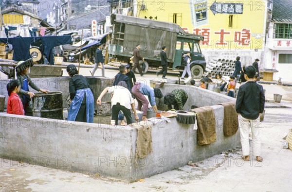 Women washing clothes in street at public laundry place, Tai Po, New Territories, Hong Kong, Asia,