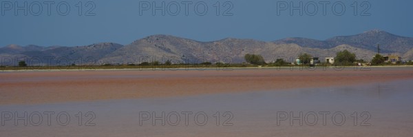 Vast landscape with mountains and huts by the lake, clear sky offered, salt lake, Tigaki, nature