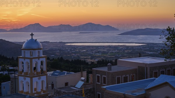 A church at sunset with a view of the sea and the islands, salt lake, Tigaki, nature reserve, hydro
