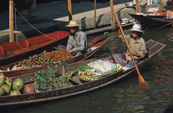 Merchants in their boats at Damnoen Saduak Floating Market, Thailand, December 2002, vintage,