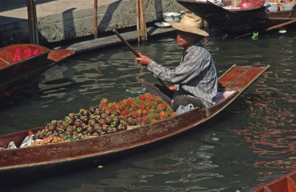 Merchant in his boat at Damnoen Saduak Floating Market, Thailand, December 2002, vintage, retro,