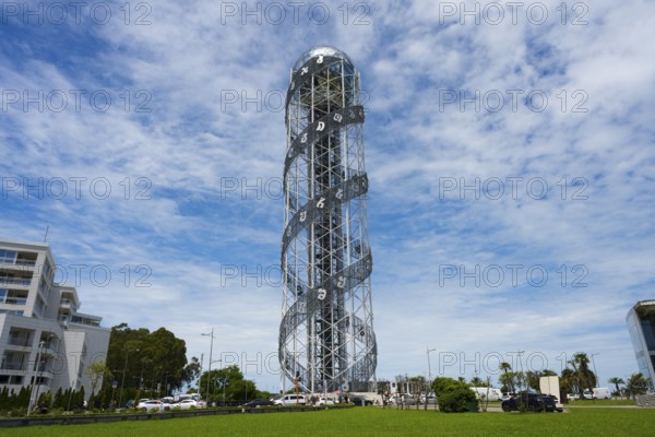 Large steel tower with spiral architecture against a slightly cloudy sky, Alphabetic Tower,