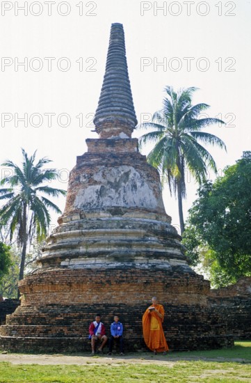 People, monk, boys, palm trees, chedi at Wat Phra Si Sanphet, Ayutthaya, Thailand, December 2002,