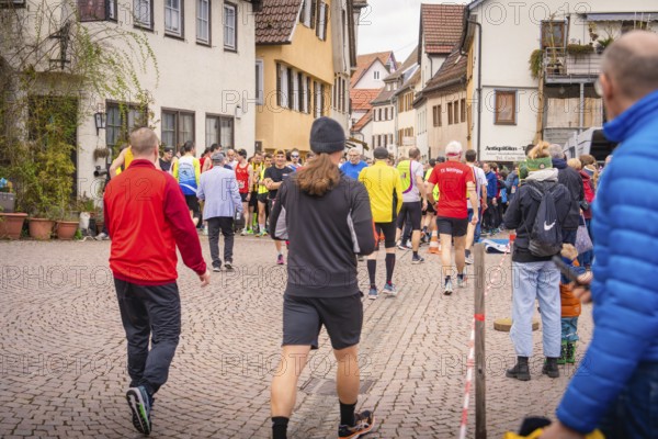 Group of people in sportswear on paved village road, triathlon, Calw, Germany