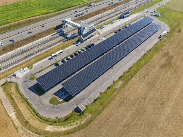 Aerial view of a parking lot with solar panels and vehicles on a street, e-charging park,