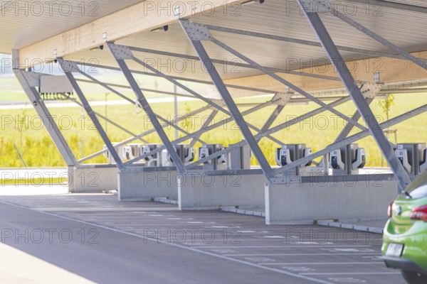 Modern architecture of a parking garage with charging stations and metal supports, e-charging park,