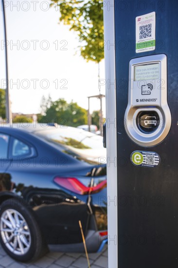 Electric car at a charging station, modern design with QR code and environmentally friendly