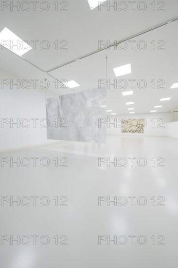 Minimalist gallery space with hanging metal artwork in the foreground, Schauwerk, Sindelfingen,