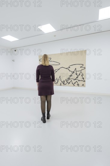 A woman stands in front of a modern work of art in a bright gallery, Schauwerk, Sindelfingen,