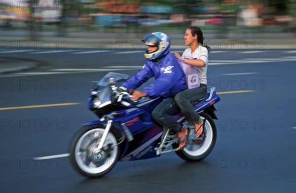 Man and woman on motorcycle, motion-blurred, Bangkok, Thailand, December 2002, vintage, retro, old,