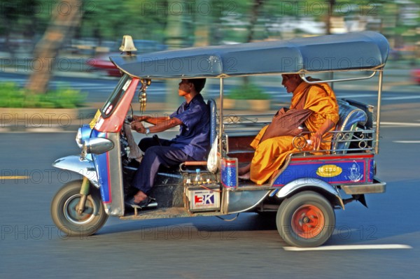 Monk in a three-wheeled tuk tuk taxi, blurred, Bangkok, Thailand, December 2002, vintage, retro,