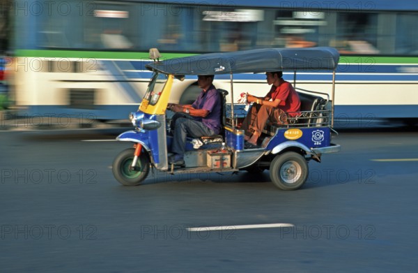 Passenger in a three-wheeled tuk tuk taxi, blurred, Bangkok, Thailand, December 2002, vintage,