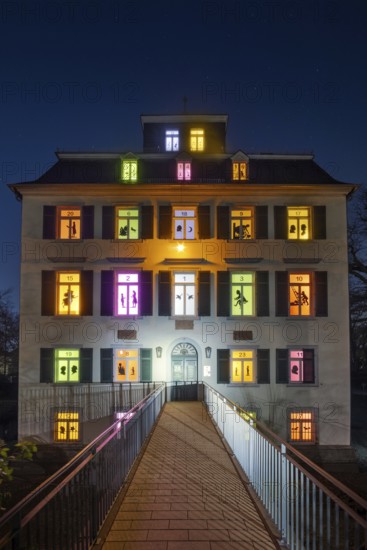 The windows of the Holzhausenschlösschen in Holzhausenpark in Frankfurt am Main shine brightly in