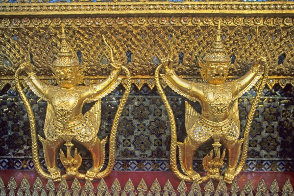 Golden mythical creatures, statues, Garudas, at Wat Phra Kaeo, Bangkok, Thailand, December 2002,
