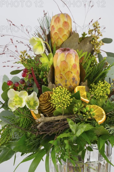 Detailed close-up of a floral arrangement with protea, Christmas rose and berries, exotically