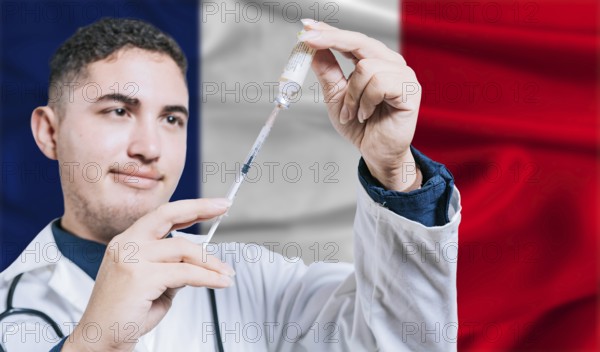 Doctor holding syringe on France flag background. Medical professional holding syringe with French