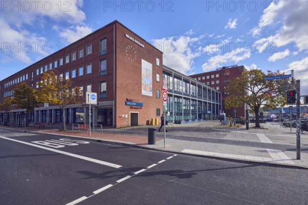 New town hall, brick building, modern architecture, façade with windows, bus lane marking,