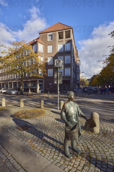 Bronze sculpture newspaper boy, sculptor Frauke Wehberg, street made of paving stones, general