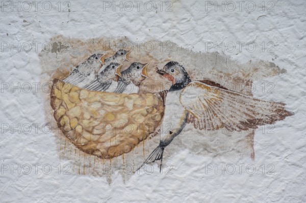 Swallow feeding her young in the nest, a painting on a farmhouse, Morschreuth, Upper Franconia,