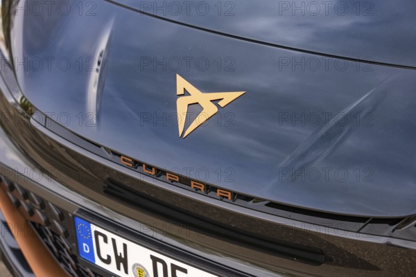 Close-up of a shiny car emblem on a dark hood, electric car Cupra, e-car sharing, Calw, Germany