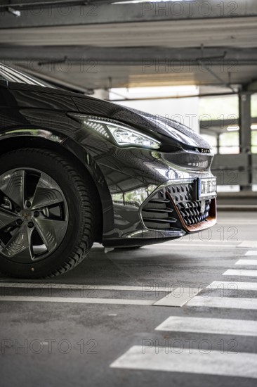 Close up of a black car in an urban parking lot from the front, electric car Cupra, e-car sharing,