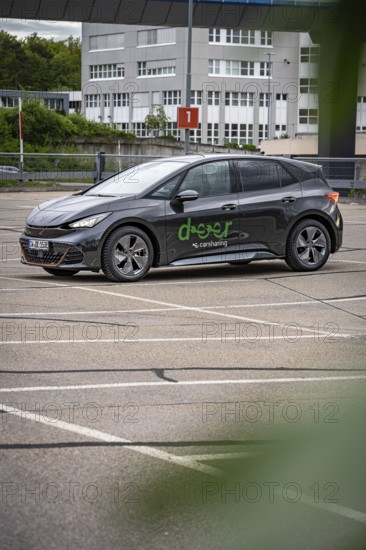 Black car sharing car parked in vacant area, modern city vehicle, Cupra electric car, e-car