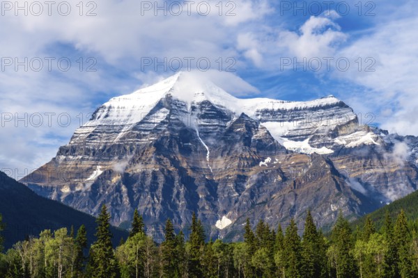 Mount robson, towering in the canadian rockies, showcases its snow capped summit and rugged slopes