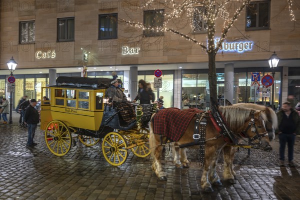 Horse-drawn carriage ride in a historic stagecoach at Chriskindlesmarkt, Hauptmarkt, Nuremberg,