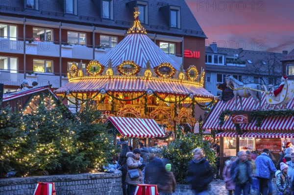 Nostalgic children's carousel at the children's Christmas market in the evening, Hans Sachs Platz,