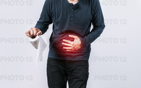 Person with toilet paper with stomach problems on isolated background, Concept of a person with