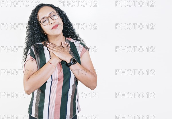 Positive afro woman with lovely sincere smile feeling thankful, relaxed afro girl showing thank you