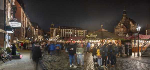 Christmas market illuminated in the evening with Frauekirche and town hall, Hauptmarkt, Nuremberg