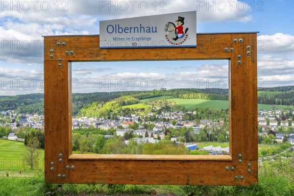 View through a large wooden frame for photographers of the town of Olbernhau and surrounding