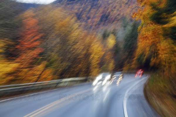 Car, light trails, rain-wet road, curvy country road, autumn leaves, Indian summer, smudge effect,