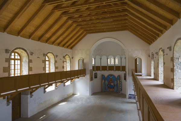 Large church room in wooden design with gallery and many windows. Light floods the room, German