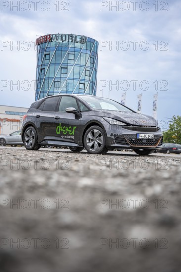 Car in front of a modern tower in a parking lot, deer e-car sharing, Cupra electric car, Böblingen,