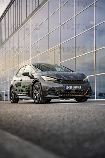 Car in front of a large glass façade of a modern office building, Deer E-Car Sharing, Cupra