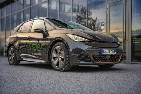 Car at dusk with reflection in a parking lot, Deer E-Car Sharing, Cupra electric car, Böblingen,