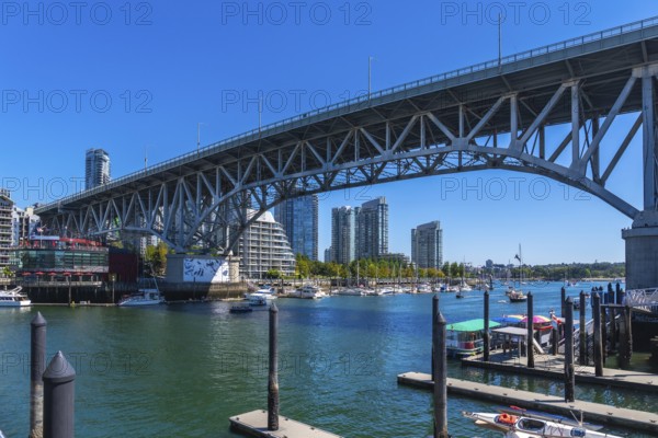 Granville street bridge dominating the vancouver skyline, connecting downtown to granville island