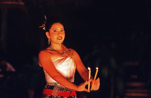 Young woman performing a traditional candle dance, Ko Phuket, Thailand, December 2002, vintage,