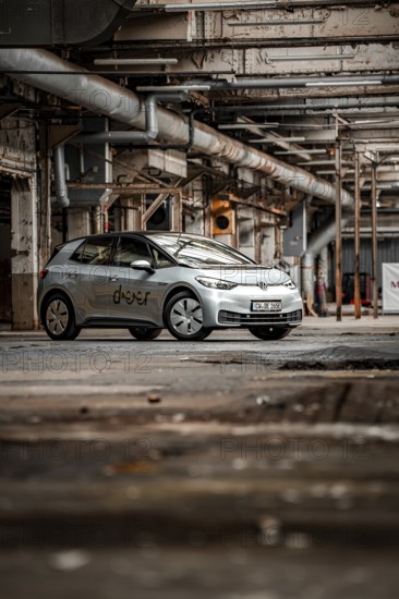 A vehicle is parked in an old factory with an industrial, raw character, Deer E-Car Sharing,