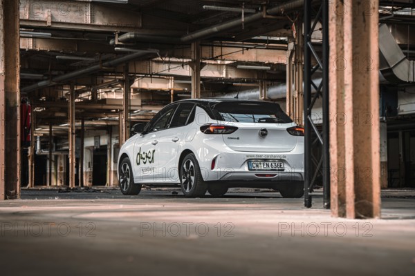 Rear view of a white car sharing car in an urban industrial building, Deer E-Car Sharing,
