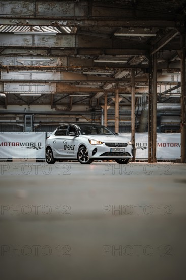 Opel car sharing vehicle parked in empty industrial building, Deer E-Car Sharing, Motorworld
