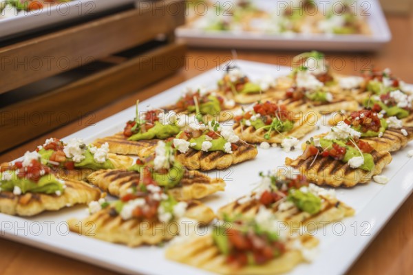 Delicious gaufres with avocado and tomatoes served stylishly piece by piece, Christmas party Dekra