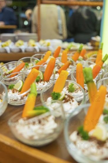 Glasses with decorative carrot garnish, elegantly placed for guests, Christmas party Dekra