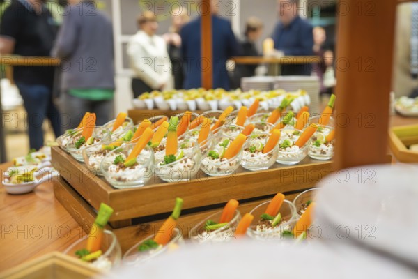 Freshly cut carrots displayed in attractive small glasses, Christmas party Dekra Congresshotel
