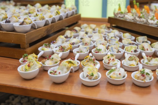 Bowls with delicious starters and colorful side dishes presented decoratively, Christmas party
